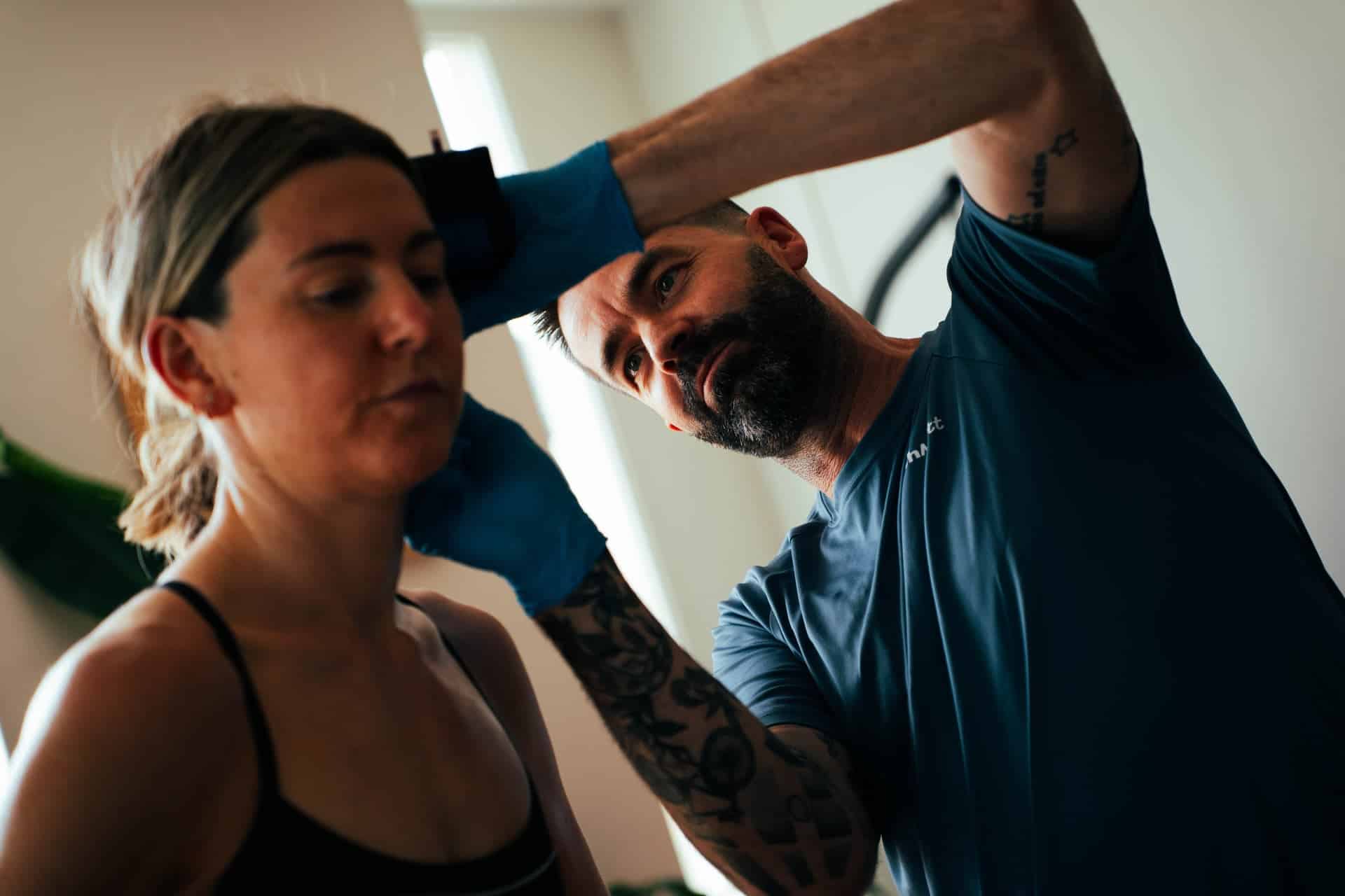 Matt takes a lactate sample from triathlete during a bike INSCYD test