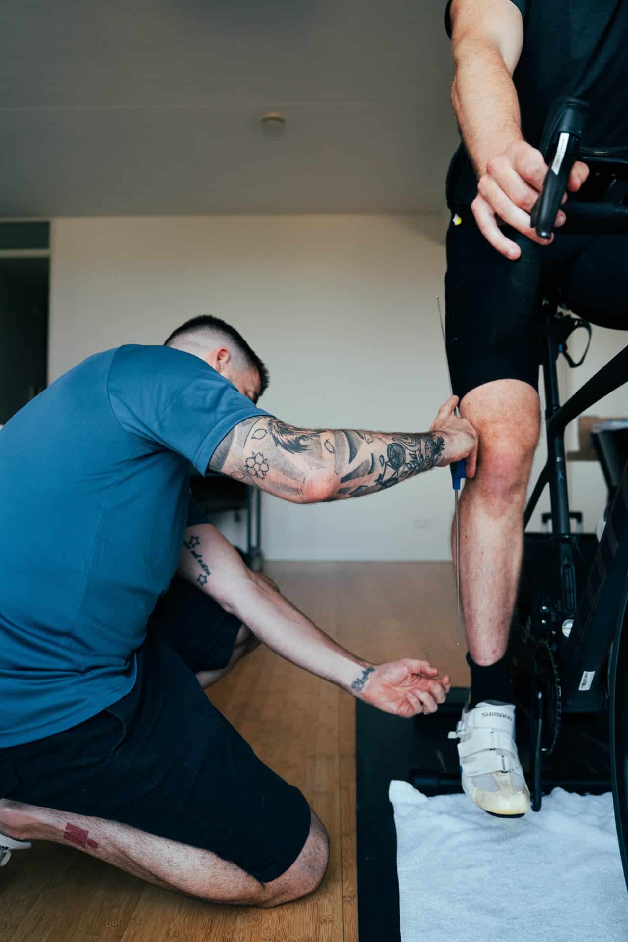 Matt measuring a triathlete on the bike during a bike fit