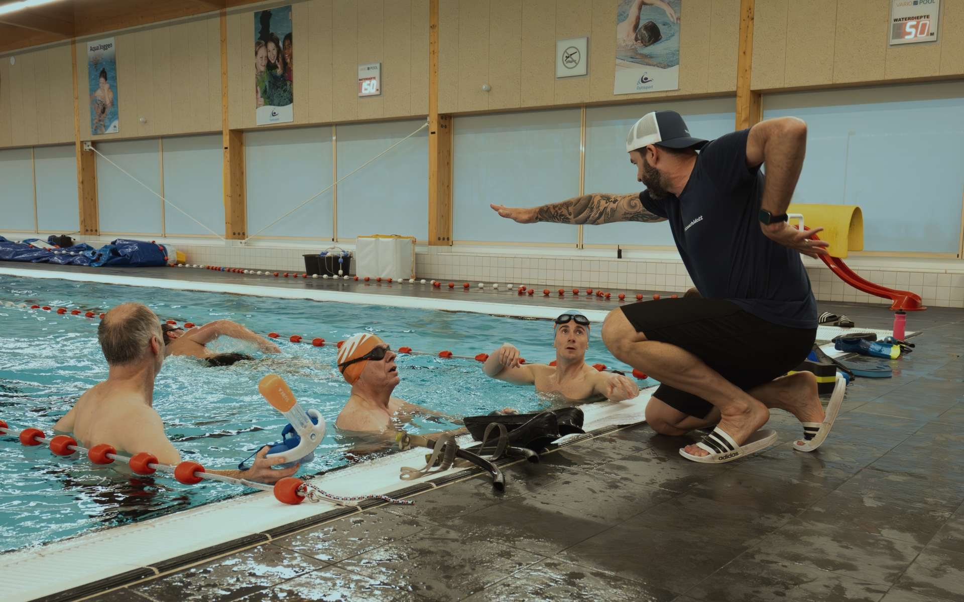 Matt coaching swimmers from the poolside during a swim session