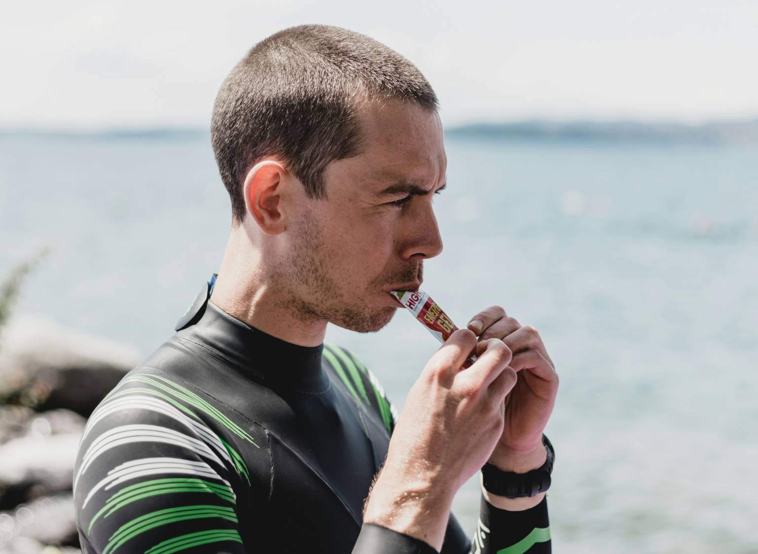 Triathlete takes gel before swim
